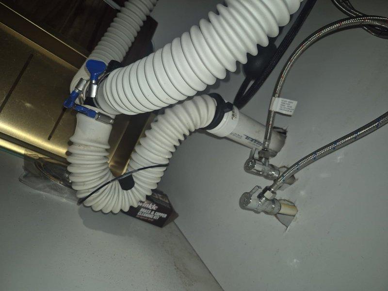 Conducted a comprehensive inspection of kitchen sink plumbing, noting non-code-compliant piping and missing trap. Evaluated existing drainage system with corrugated plastic pipes and metal braided supply lines. Also performed assessment of bathroom plumbing fixtures as requested. Documented conditions with detailed photos for estimate preparation.