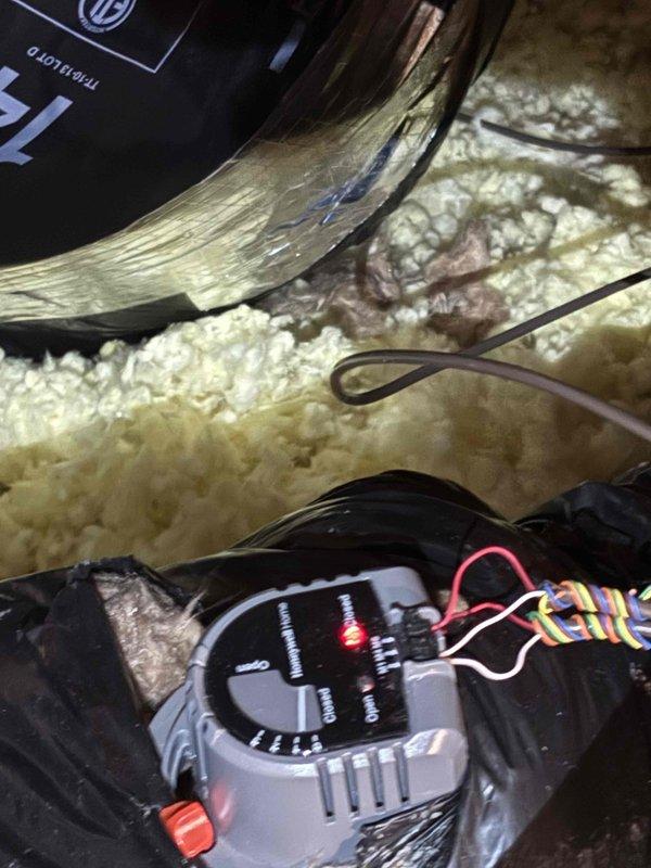 Technicians installed a 12-inch power closed Honeywell damper in a tight access area. Diagnostic testing was performed on the system wiring, and proper installation was verified with the damper positioned among insulated ductwork in the attic space.