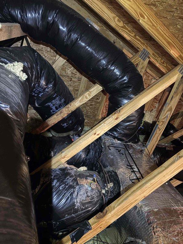 Technicians installed a 12-inch power closed Honeywell damper in a tight access area. Diagnostic testing was performed on the system wiring, and proper installation was verified with the damper positioned among insulated ductwork in the attic space.