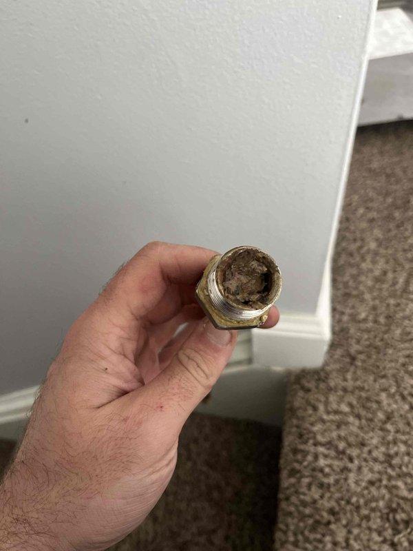 Responded to service call for furnace with overflow issue. Found drain pan completely full of water and upon inspection, discovered significant clogging in the drain line fitting with heavy sediment buildup. Cleaned debris from pipe connection and recommended installation of a safety drain pan switch to automatically shut down system if overflow occurs in future. Customer will call back to authorize recommended preventative measure.