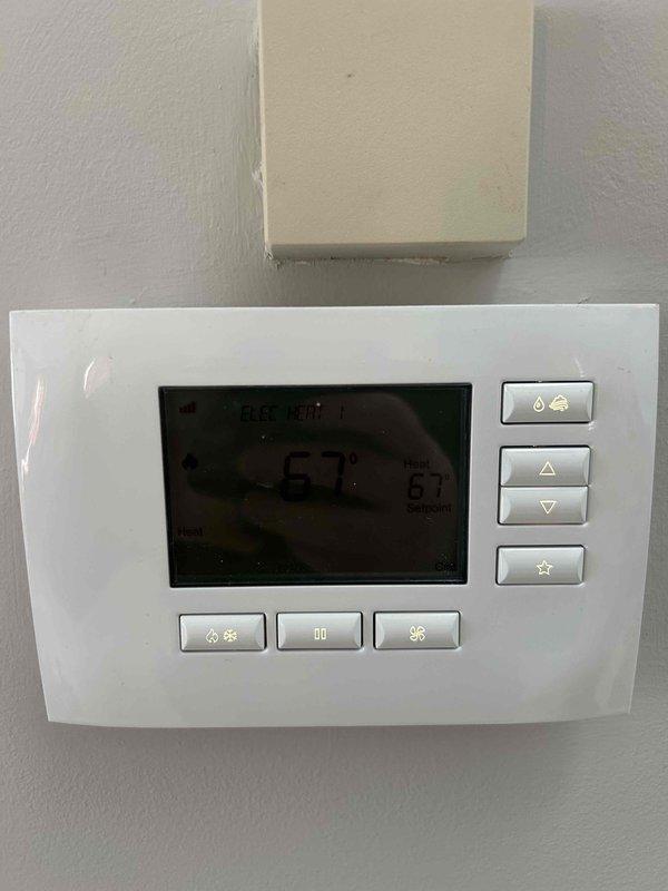 Responded to service call for heat pump with no heat. Found outdoor unit completely encased in ice with defrost cycle failure. Activated emergency heat mode to restore temporary heating while allowing system to defrost. Verified thermostat operation (showing 67°F) and educated customer on proper system operation during recovery period.