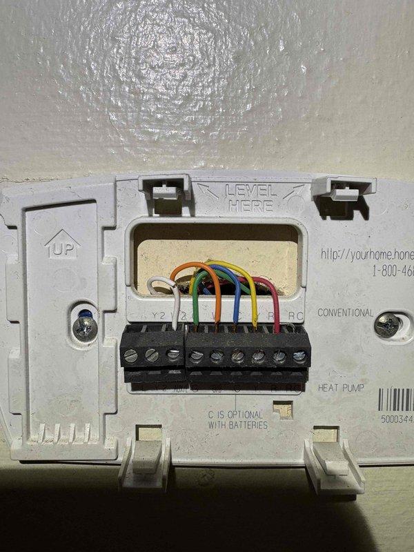 Completed cooling maintenance service on multiple systems. Inspected thermostat wiring connections for heat pump system and verified proper terminal connections. Accessed crawlspace/lower level via floor hatch to examine ductwork, noting some compression in the flexible insulated ducts that required adjustment.