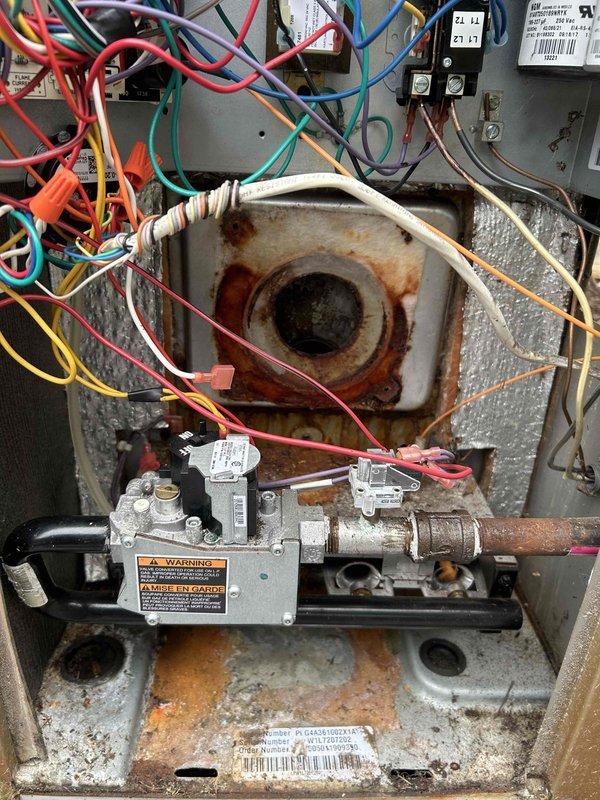 Diagnosed and replaced seized inducer motor in York furnace model PCG4A361002X1A. Multimeter testing confirmed 1.96A draw on the failed component. Extensive corrosion was observed throughout the system, particularly on the housing and base plate where moisture had accumulated.