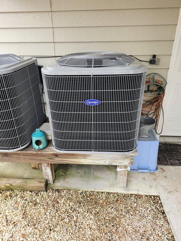 Successfully completed a comprehensive dual-system HVAC installation, replacing existing equipment with new Carrier heat pump systems. Downstairs installation included a 3-ton 15 SEER heat pump (model 27SCA536A003) with fan coil unit and 10kW electric heat kit, while upstairs received a 1.5-ton 15 SEER heat pump (model 27SCA518A003) with matching air handler and 10kW electric heat pack. Adapted metal duct transitions as needed, replaced outdoor disconnect and electrical whip, and positioned outdoor units on existing stand while reusing appropriate electrical, condensation and power lines.