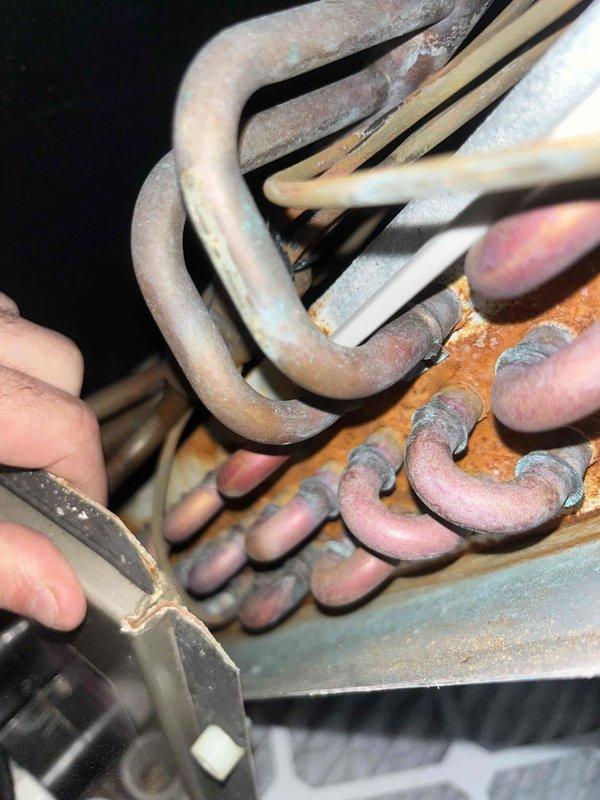 Performed cooling system inspection on two systems. Both units showed significant copper coil deterioration with extensive corrosion, oxidation, and rust formation throughout the heat exchanger components. Documented condition with detailed photos for future reference and maintenance planning.