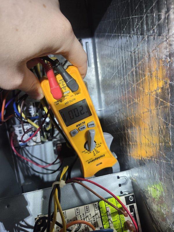 Performed routine heating maintenance on system equipped with Honeywell ProSeries thermostat. Conducted electrical diagnostics using Fieldpiece meter, testing voltage across control board terminals. System operating normally with thermostat properly calibrated and maintaining set temperature parameters.