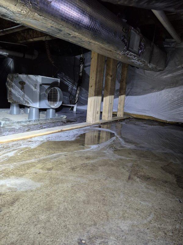Responded to service call for non-operational dehumidifier. Upon inspection, discovered standing water in crawl space with excessive moisture levels. Confirmed Aprilaire humidity controller was functioning and displaying 75% humidity with system in "ON" state. Serviced dehumidifier to restore proper operation and reduce moisture levels in the crawl space.