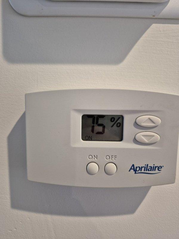 Responded to service call for non-operational dehumidifier. Upon inspection, discovered standing water in crawl space with excessive moisture levels. Confirmed Aprilaire humidity controller was functioning and displaying 75% humidity with system in "ON" state. Serviced dehumidifier to restore proper operation and reduce moisture levels in the crawl space.