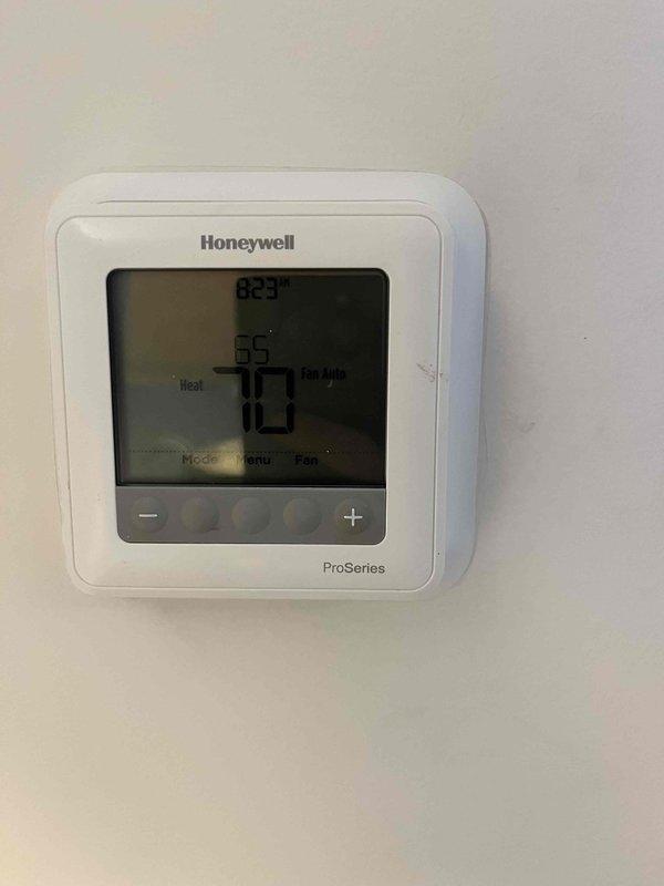 Responded to no cooling complaint where tenant had replaced batteries in Honeywell ProSeries thermostat but system would not operate afterward. Diagnosed configuration issue in thermostat settings and reprogrammed device to properly communicate with HVAC system. Verified proper operation of both heating and cooling modes before departure.