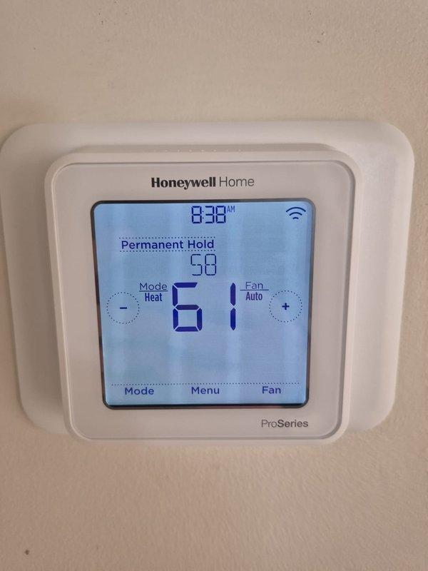 Performed routine cooling system maintenance including filter inspection. Conducted electrical component testing with multimeter, verifying proper voltage readings. System thermostat confirmed operational with correct programming and temperature settings.