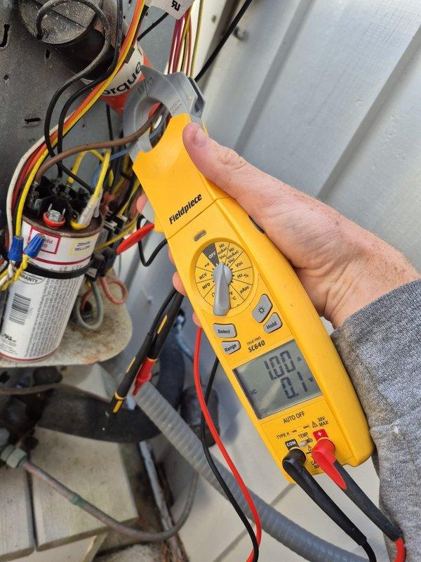 Performed routine cooling system maintenance including filter inspection. Conducted electrical component testing with multimeter, verifying proper voltage readings. System thermostat confirmed operational with correct programming and temperature settings.