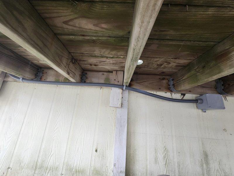 Completed installation of a complete American Standard HVAC system, including a 2.5-ton 14 SEER heat pump, air handler, 10kw electric heat kit, and digital WiFi thermostat. Removed and disposed of old equipment, installed metal duct transitions, reused existing utilities where appropriate, replaced outdoor disconnect and electrical whip, and positioned outdoor unit on existing stand. System was properly mounted on wooden deck platform with all necessary electrical conduits and refrigerant lines connected according to manufacturer specifications.