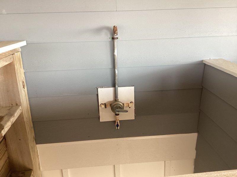 Performed de-winterization service on dual water heater system with copper piping and multiple control valves. Inspected and verified proper function of all components including brass fittings and ventilation equipment. Documented oxidation on copper plumbing fixture mounted to wall panel and confirmed system is operational and ready for regular use.