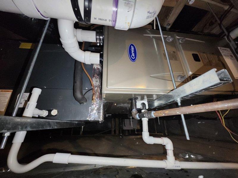 Successfully removed and disposed of old furnace and installed new Carrier 59SC2E080M17 furnace, integrating with existing coil, AC, and thermostat. System was properly connected with PVC ventilation and drainage components, and final testing confirmed proper draft pressure of 11.85 inwc. Installation includes standard manufacturer warranty coverage.