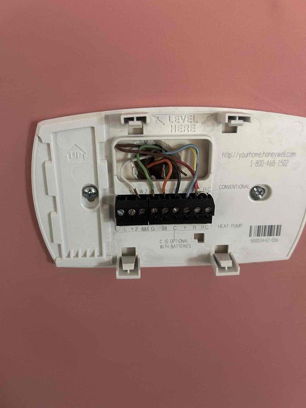 Responded to customer complaint of outdoor unit producing loud noise during startup and operation. Inspected Honeywell heat pump thermostat wiring and verified proper connections to terminal block (R, G, Y, B, W). Confirmed thermostat was functioning correctly with display showing 71°F indoor temperature, 62°F heat set point, and system in "Heat" mode with fan set to "Auto".