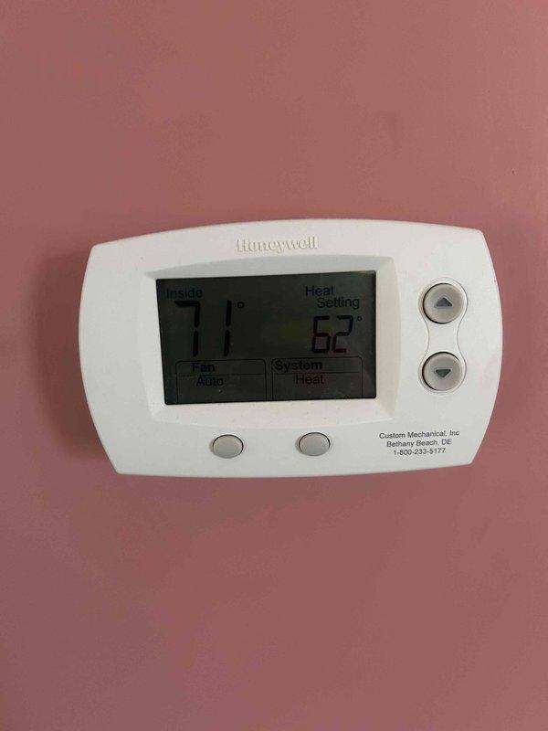 Responded to customer complaint of outdoor unit producing loud noise during startup and operation. Inspected Honeywell heat pump thermostat wiring and verified proper connections to terminal block (R, G, Y, B, W). Confirmed thermostat was functioning correctly with display showing 71°F indoor temperature, 62°F heat set point, and system in "Heat" mode with fan set to "Auto".