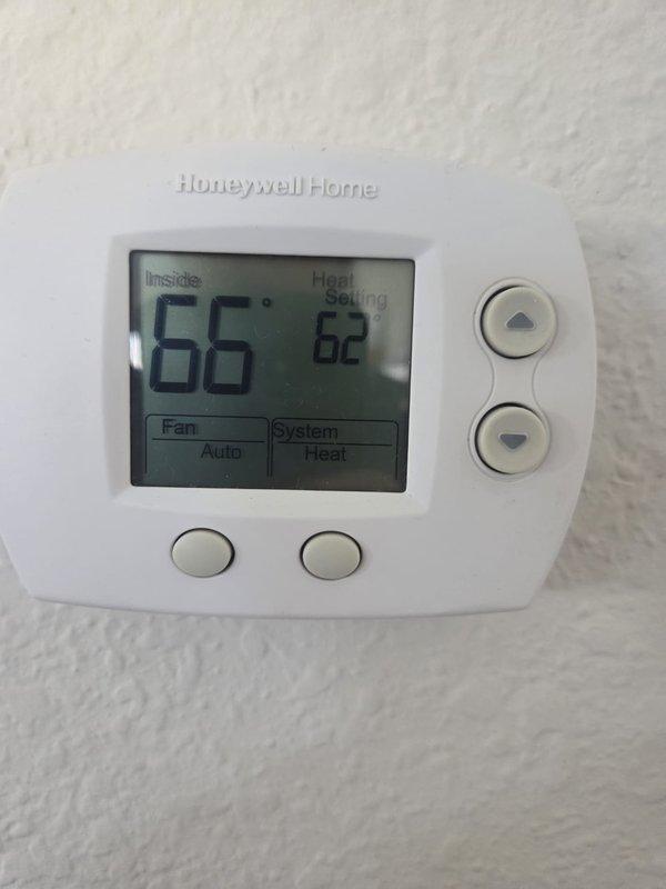 Performed scheduled cooling maintenance visit on residential system. Inspected Honeywell thermostat functionality (displaying 66°F indoor temperature with 62°F heat setpoint) and verified system operation in heat mode. Conducted electrical diagnostics using Fieldpiece SC260 clamp meter, recording 0.60 amp reading on primary components to confirm proper electrical performance.