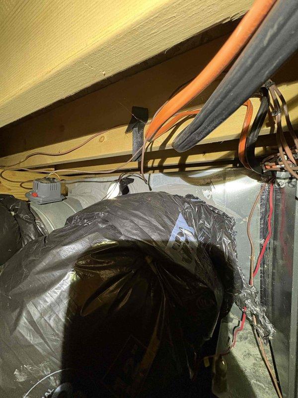 Responded to no heat service call where customer reported system not maintaining set temperature. Inspection revealed compromised ductwork insulation and improper conduit installation in the utility space. Repaired and resealed insulation on main supply duct and secured loose electrical wiring to restore proper system function and heating capacity.