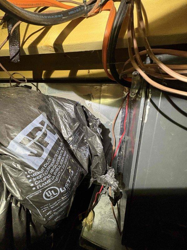 Responded to no heat service call where customer reported system not maintaining set temperature. Inspection revealed compromised ductwork insulation and improper conduit installation in the utility space. Repaired and resealed insulation on main supply duct and secured loose electrical wiring to restore proper system function and heating capacity.