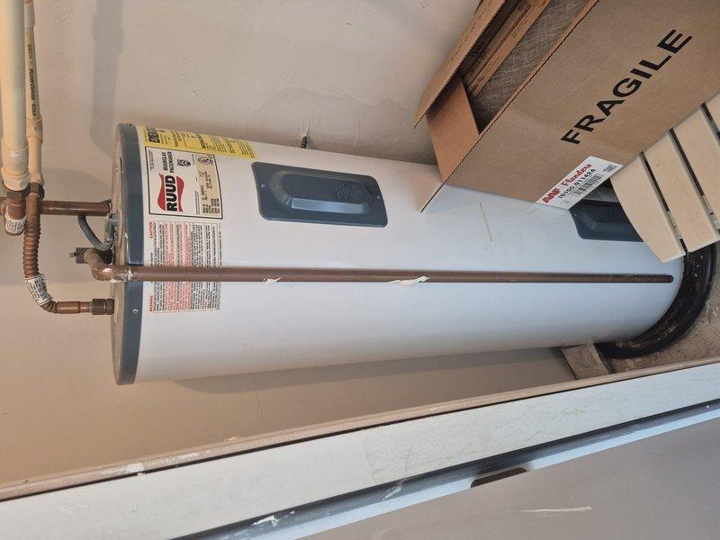 Conducted routine cooling maintenance visit using key D35. Inspected water heater system including Ruud tank with digital display, expansion tank, and copper piping configuration. All components appeared in good working condition with no visible leaks, damage, or corrosion detected.