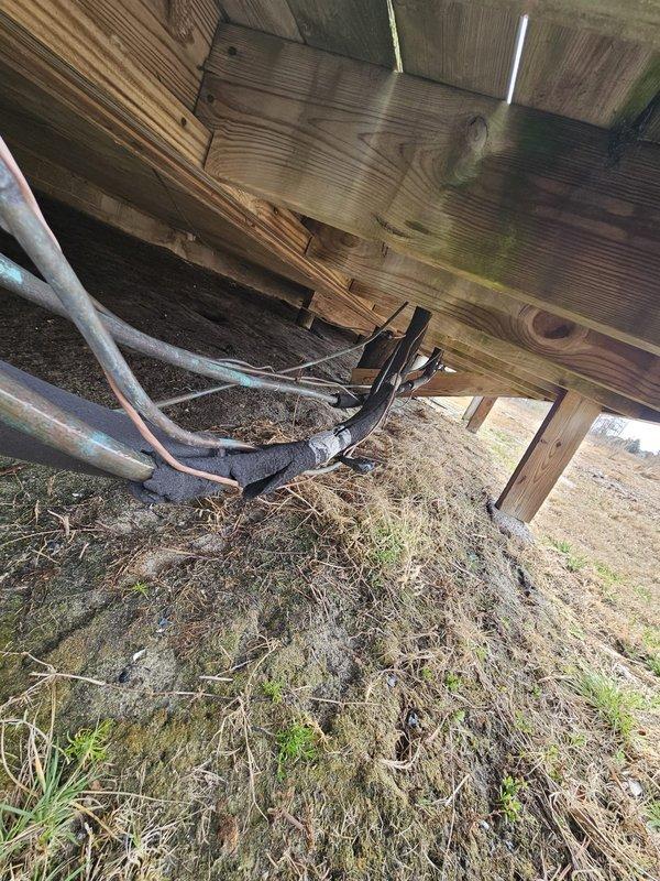 Conducted visual inspection of HVAC cooling system, identifying exposed electrical wiring requiring proper conduit installation. Observed significant moisture damage to exterior wall near condenser unit and recommended remediation to prevent further deterioration and potential system damage.