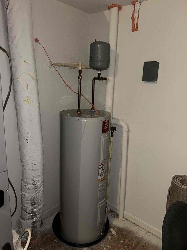 Performed scheduled cooling system maintenance and collected information for water heater replacement estimate as requested. System was operational at time of service, with photos taken of current water heater installation showing tank, expansion tank, and associated plumbing components for replacement sizing purposes.