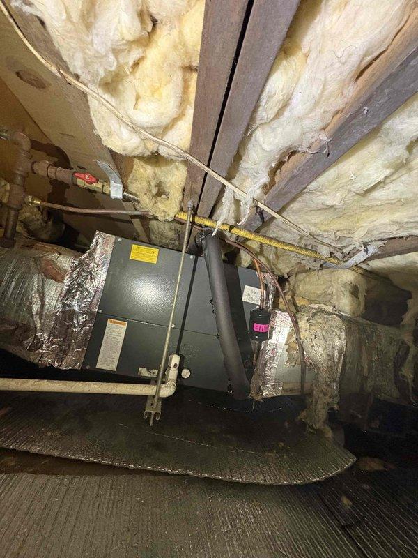 Performed comprehensive cooling maintenance visit on HVAC system located in crawl space. Inspected air handler unit mounted on platform, checked all connections including refrigerant lines, electrical components, and ductwork with foil insulation. Verified system operation with particular attention to the electrical connections in junction box and copper piping integrity.