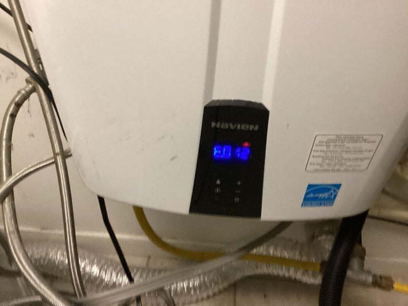 Responded to service call for a Navien tankless water heater system showing error code E432. Diagnosed and repaired the non-functioning unit of two installed tankless water heaters, restoring hot water service to the property. Verified proper operation of both units before completion.