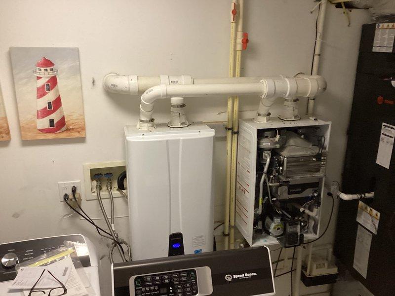Responded to service call for a Navien tankless water heater system showing error code E432. Diagnosed and repaired the non-functioning unit of two installed tankless water heaters, restoring hot water service to the property. Verified proper operation of both units before completion.