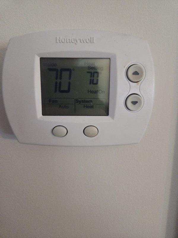 Performed cooling system evaluation for customer considering home addition. Checked thermostat functionality (Honeywell unit showing proper operation at 70°F) and measured system amperage (5.22 amps) with Fieldpiece SC260 clamp meter. Advised customer that additional load capacity analysis would be required to determine if existing unit can adequately service the expanded square footage.