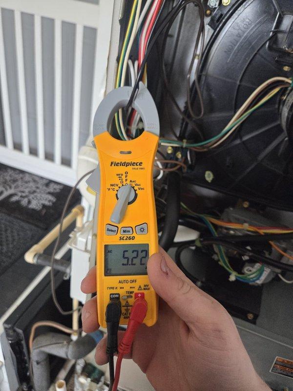 Performed cooling system evaluation for customer considering home addition. Checked thermostat functionality (Honeywell unit showing proper operation at 70°F) and measured system amperage (5.22 amps) with Fieldpiece SC260 clamp meter. Advised customer that additional load capacity analysis would be required to determine if existing unit can adequately service the expanded square footage.