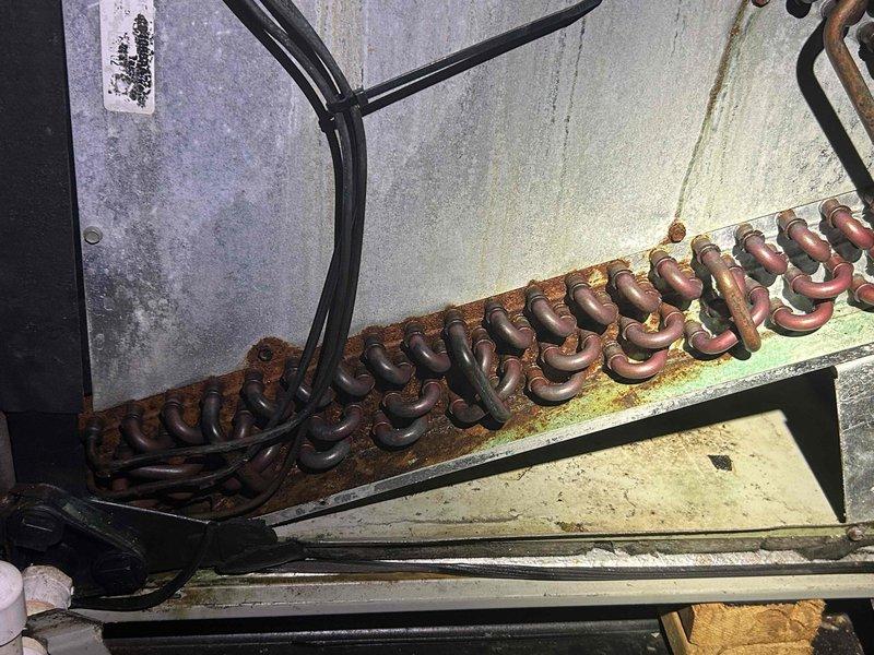 Performed scheduled geothermal system inspection on dual-system setup. Identified significant corrosion on evaporator coil mounting surface and weatherstripping deterioration on downstairs unit. Completed cooling system check (Q150/240) and documented that downstairs system cover requires replacement. Comprehensive tune-up included electrical testing with clamp meter and visual inspection of all accessible components.