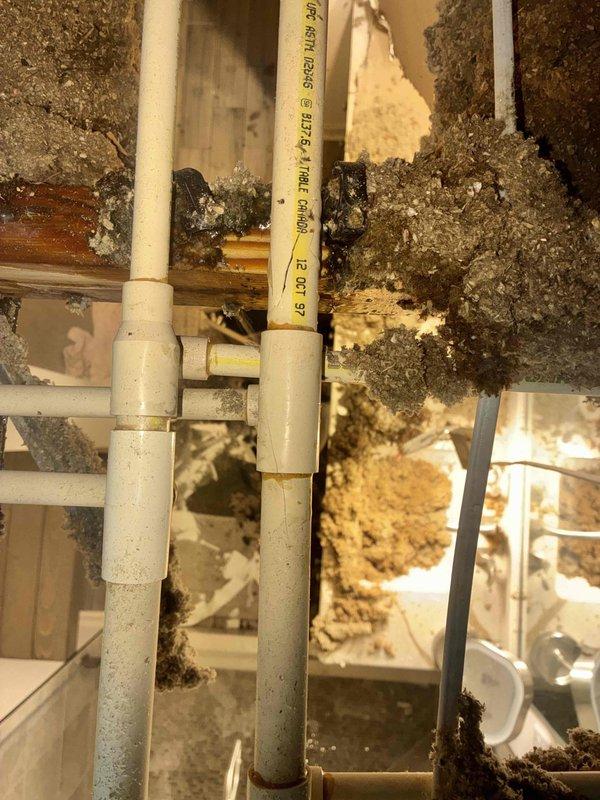 Responded to emergency call for ceiling collapse in master bathroom due to water leak. Inspected damaged area revealing significant ceiling failure with exposed joists and insulation. Located and repaired leaking PVC supply pipe in ceiling cavity, ensuring proper connections and sealing to prevent future water damage.