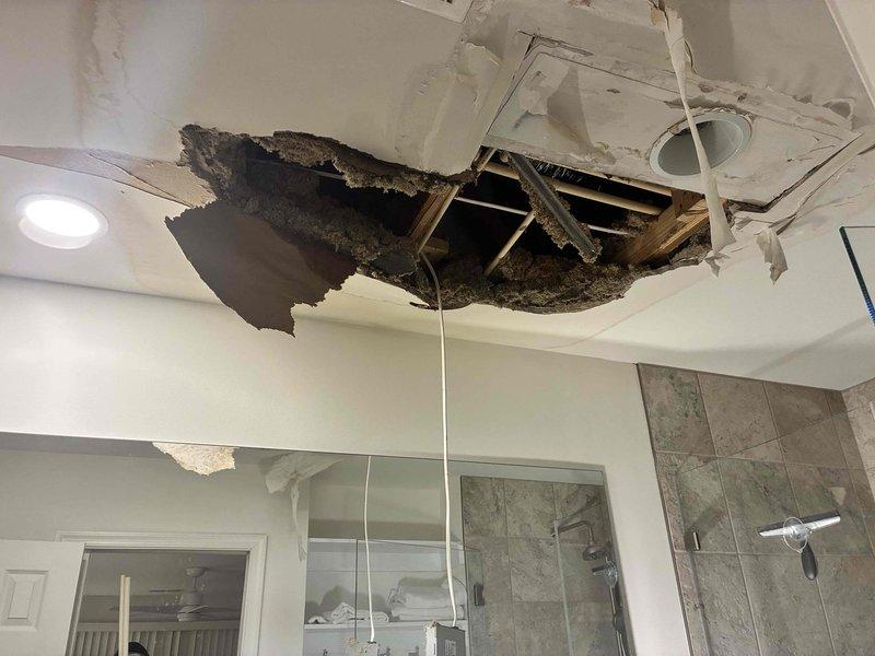Responded to emergency call for ceiling collapse in master bathroom due to water leak. Inspected damaged area revealing significant ceiling failure with exposed joists and insulation. Located and repaired leaking PVC supply pipe in ceiling cavity, ensuring proper connections and sealing to prevent future water damage.