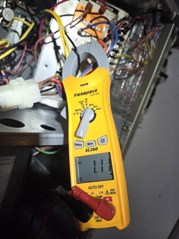 Performed scheduled cooling maintenance visit. Conducted electrical testing with Fieldpiece SC260 clamp meter, measuring electrical parameters at 1.1 reading. Verified proper operation of Honeywell Home thermostat (showing 55°, Fan Heat/Auto settings). System now functioning correctly after service completion.