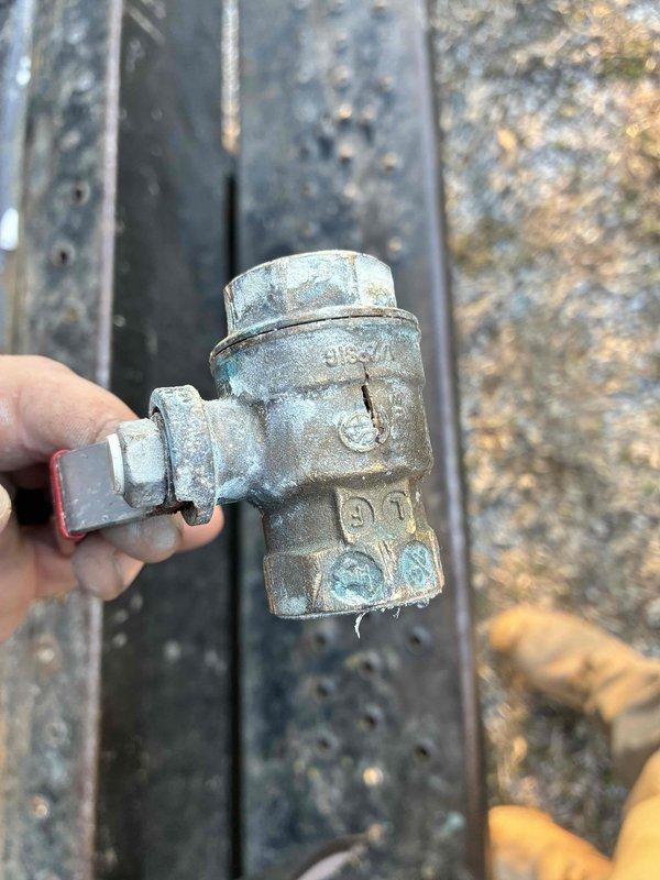 Responded to emergency call for burst water pipe outside residence. Isolated water supply and replaced damaged section of galvanized plumbing valve that showed significant corrosion and mineral buildup. Installed new brass fitting to restore proper water flow and prevent future leakage.