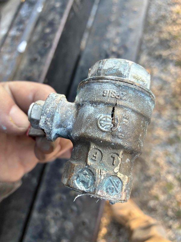 Responded to emergency call for burst water pipe outside residence. Isolated water supply and replaced damaged section of galvanized plumbing valve that showed significant corrosion and mineral buildup. Installed new brass fitting to restore proper water flow and prevent future leakage.