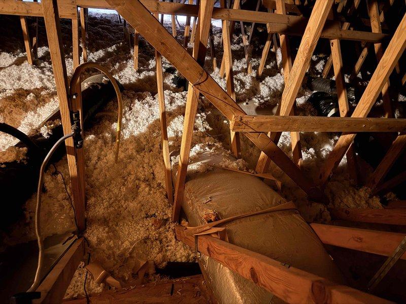 # HVAC Estimate - Replacement Summary

Conducted site evaluation for 17-year-old geothermal system replacement serving upper level of residence. Primary concern identified as leaking indoor coil in basement-mounted geo cube unit, necessitating complete system replacement due to age and condition of equipment.

Assessed existing upstairs air handler installation, originally converted from furnace configuration in 2009. Inspection revealed current system operating on inadequate 14-gauge wiring with 15-amp breaker and no auxiliary heat capability. Documented attic-mounted ductwork distribution system with metallic flexible ducts and existing insulation conditions. Examined basement mechanical room housing white air handler unit with associated refrigerant lines and condensate piping.

Provided comprehensive replacement quote for new geothermal system including indoor coil and air handler. Advised customer that installation of air handler with auxiliary heat kit will require licensed elect