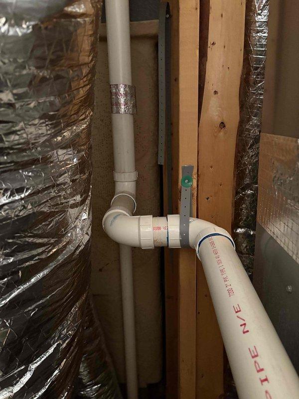 # HVAC Maintenance - Cooling System Service

Responded to service call for cooling system evaluation. Upon arrival, performed comprehensive cool check on residential air conditioning system. Inspected refrigerant line set installation along building exterior, verifying proper insulation integrity and secure mounting of black foam-wrapped lines. Examined indoor components including condensate drain piping configuration in attic space, confirming proper PVC drain line installation and connections. All refrigerant lines showed appropriate insulation coverage with no visible damage or deterioration. Condensate drainage system functioning properly with correct pitch and secure mounting. System operational and cooling effectively at time of inspection.