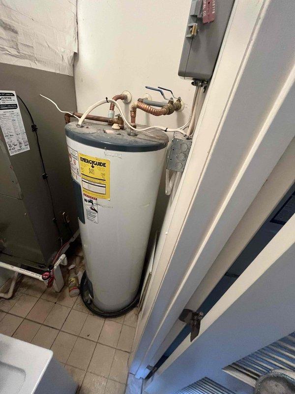 Completed scheduled cooling system maintenance visit at vacation rental property. Coordinated with property management regarding thermostat settings and access. Performed standard cooling season inspection of HVAC equipment located in utility closet adjacent to laundry area, verified system operational status, and documented equipment condition through photographic records for service files.