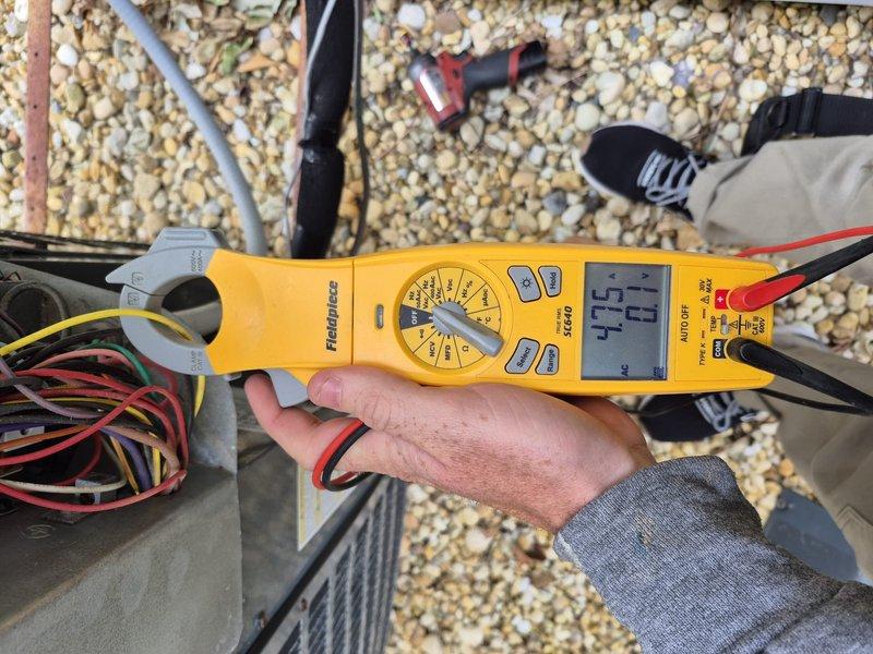 Performed comprehensive cooling system maintenance on rooftop HVAC unit. Conducted electrical diagnostics using clamp meter to verify voltage and amperage readings across multiple circuits, measuring power supply connections at the electrical junction box. All electrical components tested within normal operating parameters, and system confirmed operational for continued service.