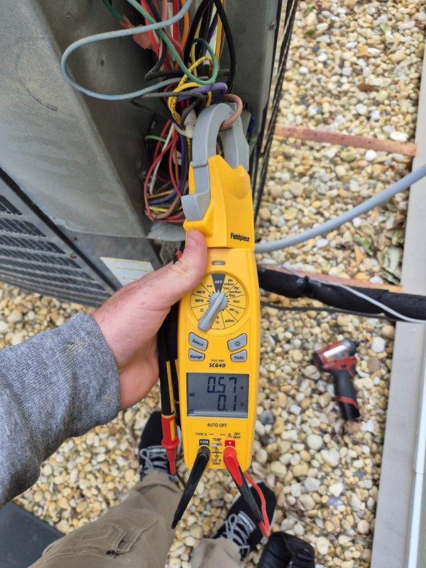 Performed comprehensive cooling system maintenance on rooftop HVAC unit. Conducted electrical diagnostics using clamp meter to verify voltage and amperage readings across multiple circuits, measuring power supply connections at the electrical junction box. All electrical components tested within normal operating parameters, and system confirmed operational for continued service.