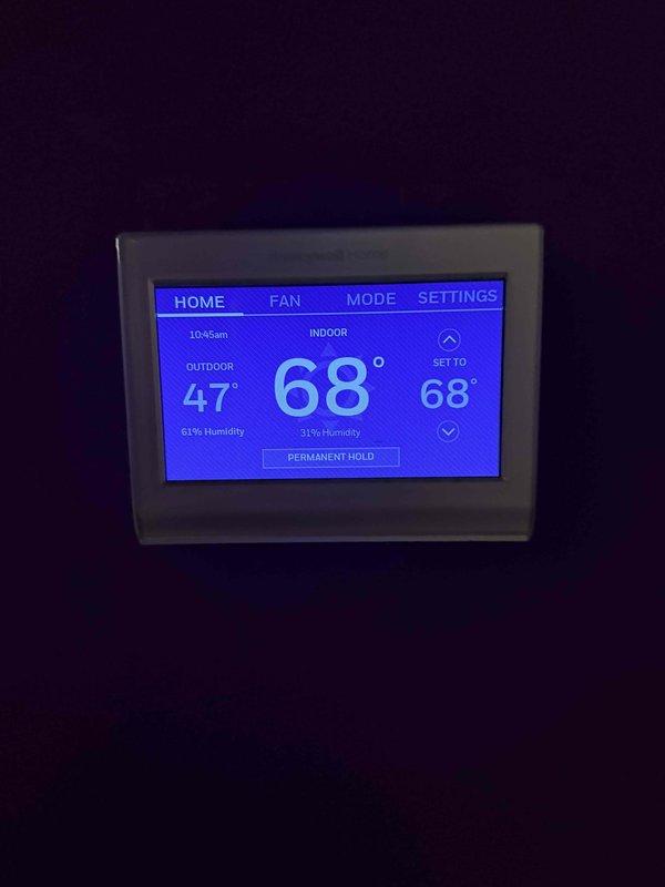 Conducted site assessment for complete HVAC system replacement at residential property. Evaluated existing upstairs air handler unit and thermostat, which was experiencing inadequate heating performance. Documented current equipment specifications and conditions, including digital thermostat displaying 68°F setpoint with outdoor temperature at 47°F. Provided estimate for replacement of both upstairs and downstairs HVAC systems, with priority given to upstairs unit due to poor heating performance and customer comfort concerns.