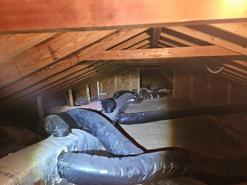 Completed comprehensive residential ductwork assessment in attic space, documenting existing HVAC distribution system including flexible ductwork routing, insulated supply lines, and structural clearances. Evaluated current duct configuration, insulation conditions, and identified areas requiring modification or replacement to optimize airflow efficiency and system performance.