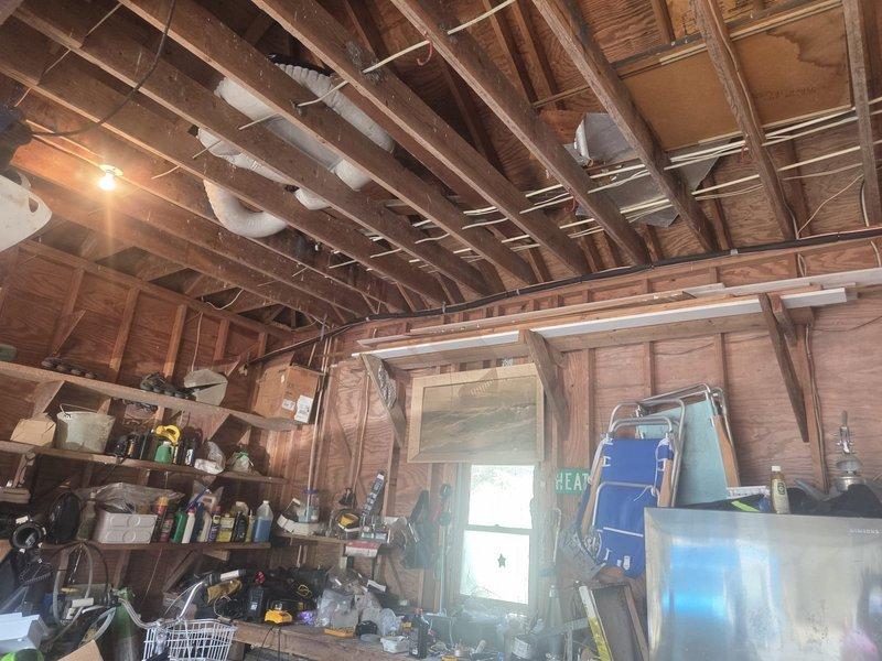 Removed and disposed of existing first-floor HVAC system. Installed 2-ton 14 SEER heat pump outdoor unit (model 5A6H4024) on existing concrete stand. Installed new fan coil unit (model 5TEM4B02) with 10KW electric heat strip and breaker. Ran new refrigeration lines exposed through garage rafters, routing up and over to outdoor unit. Abandoned existing underground refrigerant lines. Installed new 1-inch filter rack, electrical whip, and disconnect at outdoor unit. Utilized existing thermostat for system control. System tested and operational with one-year parts and labor warranty on first-floor equipment.
