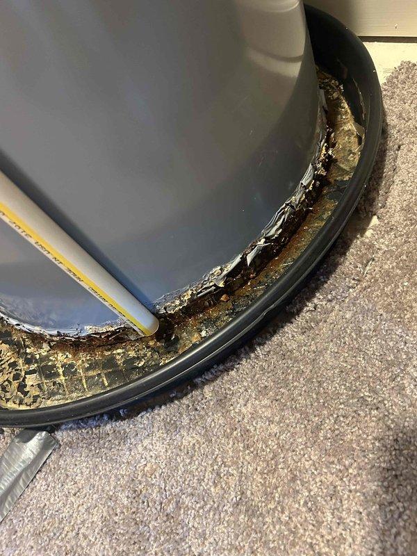 Replaced customer-supplied Goodman drain pan on HVAC air handler unit due to severe corrosion and deterioration caused by long-term water damage. Extensive rust and mineral deposits were evident throughout the base and interior walls of the original pan, with moisture damage extending to surrounding areas. Installation required approximately 3-4 hours and included proper fitting of 2" PVC couplings for drainage system connections, with warranty documentation completed for component removal and replacement.