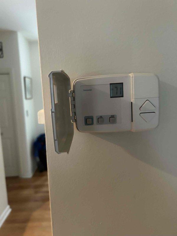 Performed routine cooling system maintenance on two residential air conditioning units. Inspected thermostat operation and verified proper display function and control settings. Evaluated both outdoor condenser units, confirmed fan operation, checked mounting stability on concrete pads, and assessed overall equipment condition with minor surface rust noted on mounting hardware but no operational concerns identified.