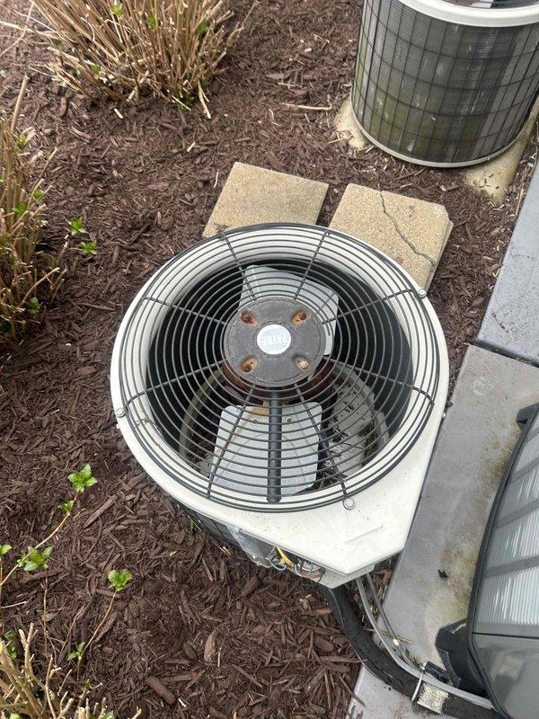 Performed routine cooling system maintenance on two residential air conditioning units. Inspected thermostat operation and verified proper display function and control settings. Evaluated both outdoor condenser units, confirmed fan operation, checked mounting stability on concrete pads, and assessed overall equipment condition with minor surface rust noted on mounting hardware but no operational concerns identified.