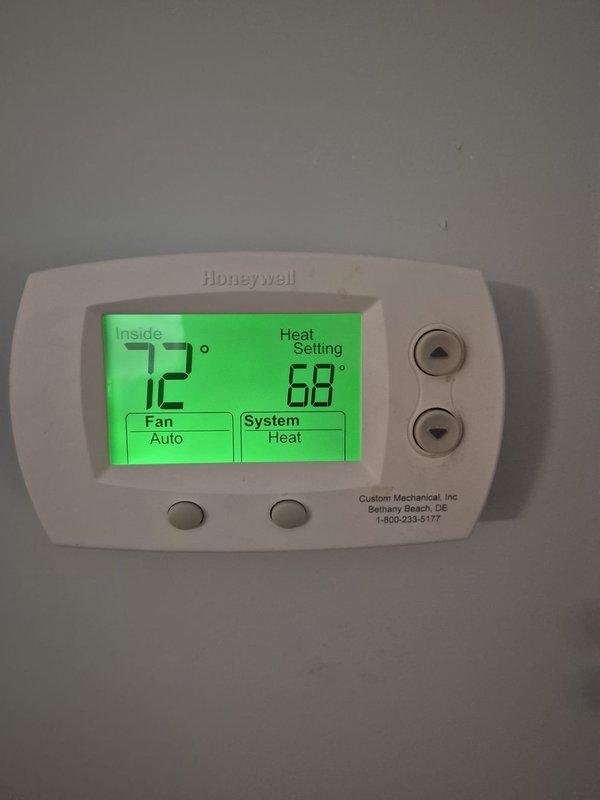 Performed routine cooling maintenance visit on HVAC system. Verified thermostat operation showing 72°F inside temperature with system functioning in heating mode set to 68°F. Conducted electrical diagnostics using clamp meter, recording voltage reading of 209V with 0.0A amperage at time of measurement, confirming proper electrical supply to equipment.