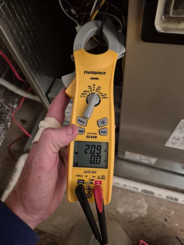 Performed routine cooling maintenance visit on HVAC system. Verified thermostat operation showing 72°F inside temperature with system functioning in heating mode set to 68°F. Conducted electrical diagnostics using clamp meter, recording voltage reading of 209V with 0.0A amperage at time of measurement, confirming proper electrical supply to equipment.